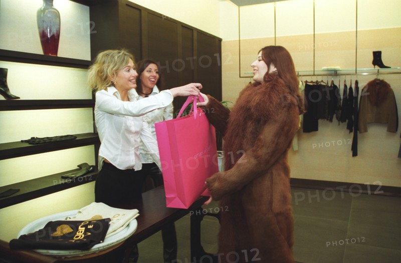 Moscow, russia, 2003, customer and staff of an expensive store in crocus city shopping center, moscow.