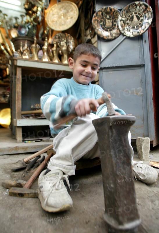 Baghdad, iraq, february 10 2003, a young craftsman pictured at work in a street of old baghdad.