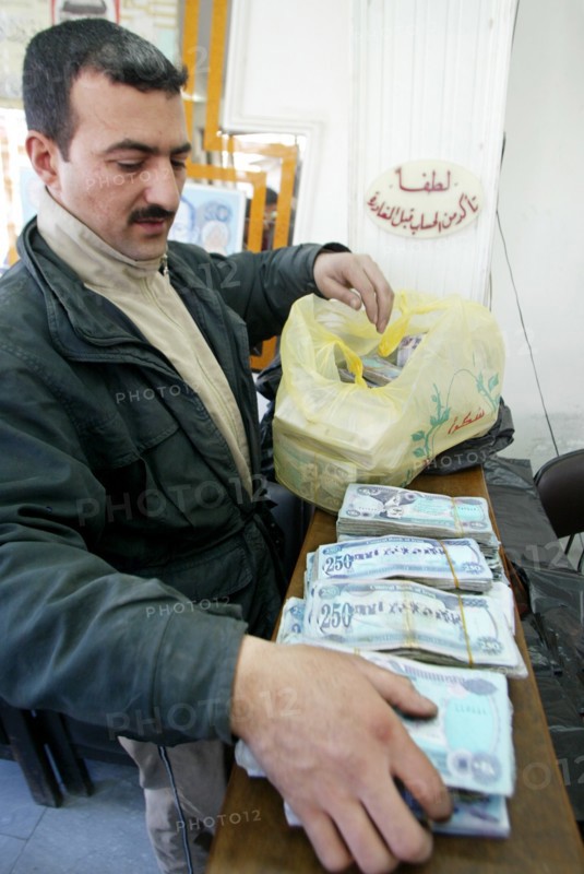 Baghdad, iraq, february 14 2003: an exchange office in baghdad, money is brought here in sacks because of the low price of the national currency - dinar, (photo itar-tass / vitaly belousov)  .