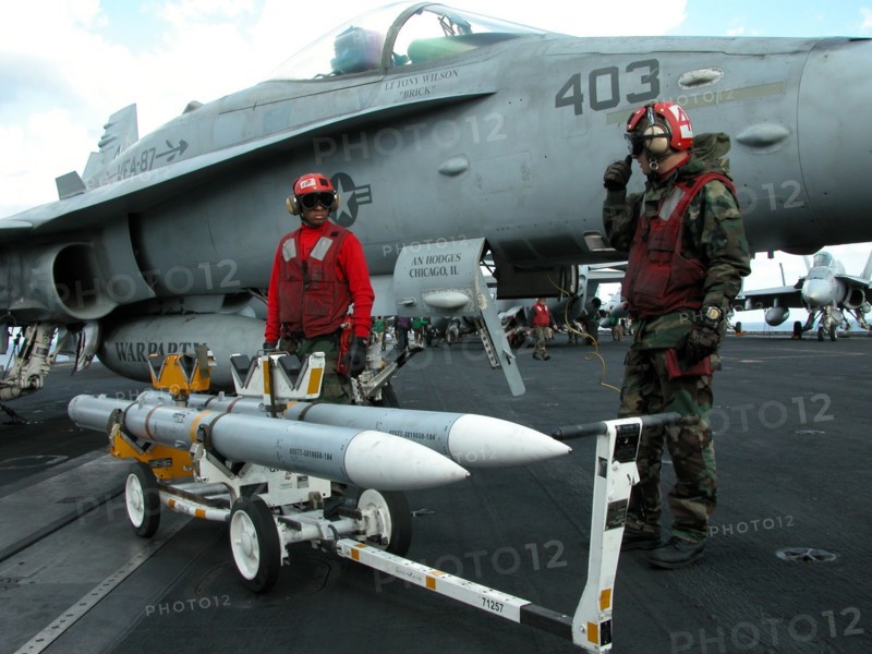 Caption: tas15: mediterranean sea, uss theodore roosevelt, march 22, 2003, servicemen removing unused aim-120 air-to-air missiles from a fa18 hornet fighter after the aircraft returned on board of the theodore roosevelt carrier from the first raid on iraq, (photo itar-tass / konstantin yelovsky) .