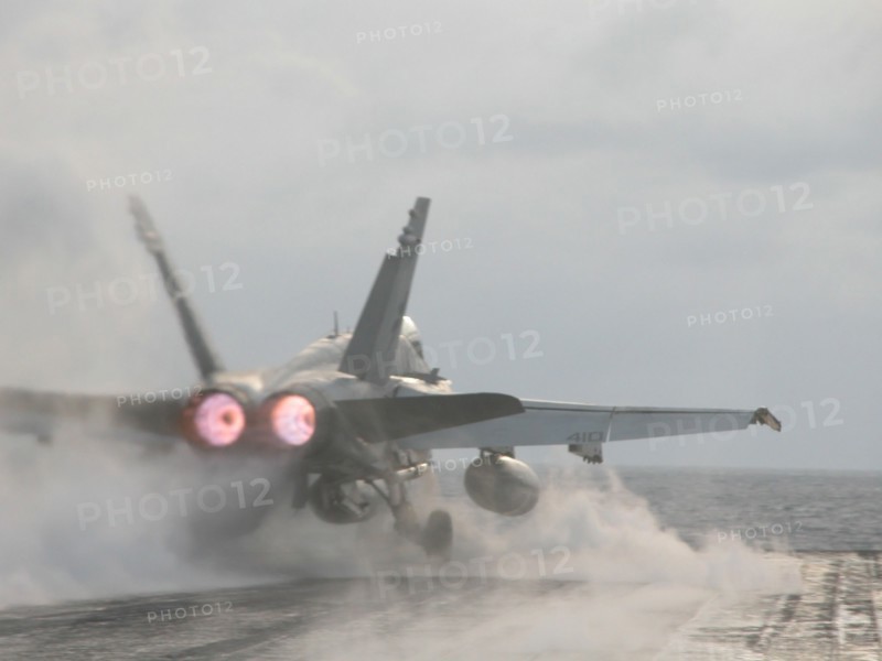 Uss 'theodore roosevelt' aircraft carrier, mediterranean sea, march 26 2003, a hornet fa-18 fighter pictured taking off from the flying-on deck of the uss 'theodore roosevelt' aircraft carrier for an execution of a combat mission.