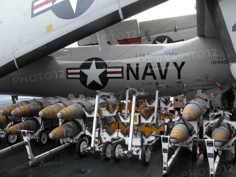 Uss 'theodore roosevelt ' aircraft carrier, mediterranean sea, march 26 2003, the jdam bombs pictured against the background of a e-2-c radio-electronic warfare plane on the deck of the uss 'theodore roosevelt ' aircraft carrier.