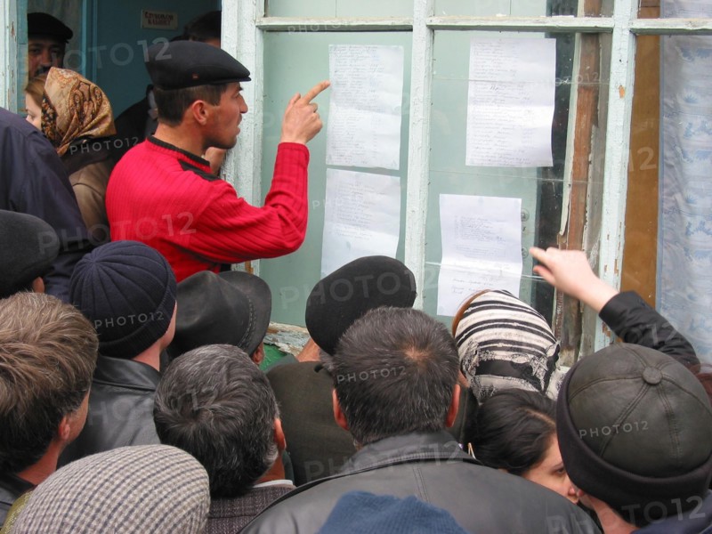 Makhachkala, russia, april 10, 2003, relatives pictured scrutinizing the list of victim of the tragedy happened in a boarding school for deaf and dumb children which was ablazed on thursday having killed 28 people over a hundred children were taken to the hospitals.