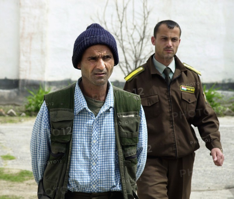 A drug-trafficer arrested by the tajik police, tajikistan, april 16, 2002, 40-year-old safar rakhmonov (l) was captured with 30 kg of heroin in his belongings by russian border guards and local police in the course of a joint operation,the trespasser explained to the police that he had been taken hostage by the narcodealers in afganistan who offered him to deliver the batch of drugs to tajikistan for his liberation.