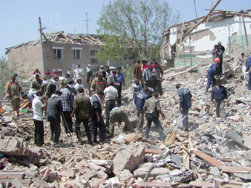 Chechnya, russia, may 12, 2003, people pictured clearing the debris in the village of znamenskoye where a powerful explosion ruined the buildings that housed the district administration ,on monday, many people were killed and injured in the terrorist act.