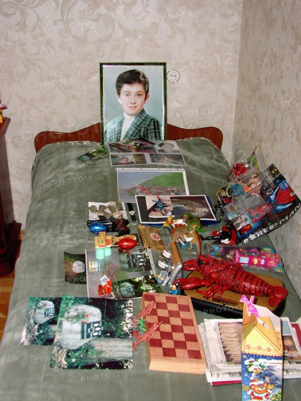 The portrait, bed and toys of a 10-year-old kostya - the son of a construction engineer vitaly kaloyev, who is suspected of the murder of a swiss air traffic controller peter nielsen, north ossetia, russia, february 27 2004.