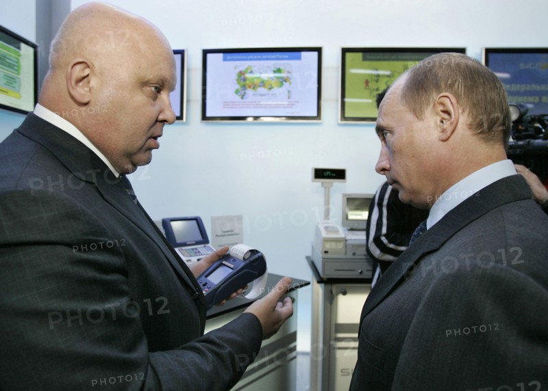 Russian president vladimir putin, right, listens to alexander goncharuk, president of joint stock financial corporation sistema, as they attend a sitronics exhibition in zelenograd, 24 miles north-west of moscow, october 17, 2006.