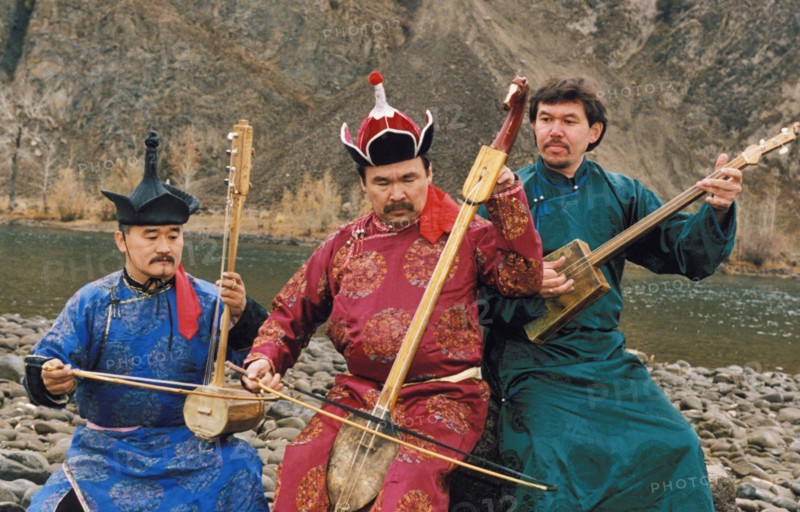 Members of the tuvan folk group, hun-huur-tu, performing by a river, tuva, russia.