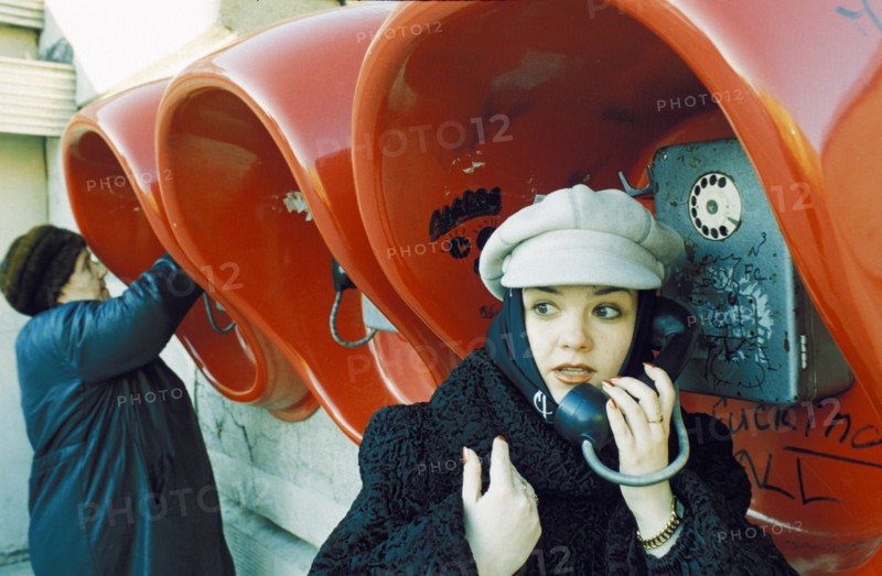 Fashionable young woman at the public phones in lipetsk which have been free since 1996, april 2001.