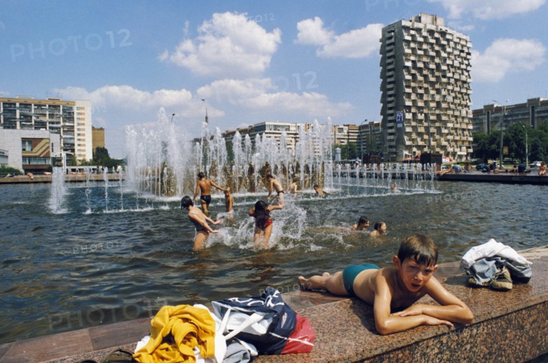 Childen playing in a public fountain in samara, july 1999.