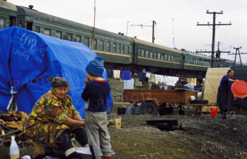 Chechen refugees outside the train they live in at the sleptsovskaya railway terminal, ingushetia, russia, november 1999.