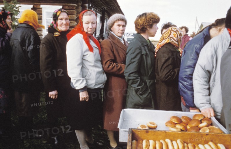 Residents of a village of berezkino in the kirov region of the ussr line up to buy rolls on may day eve during the times of economic reforms, 1990.