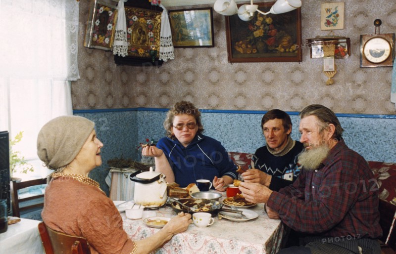 The dorogovichev family sitting down for a meal in their home in novgorod, russia.