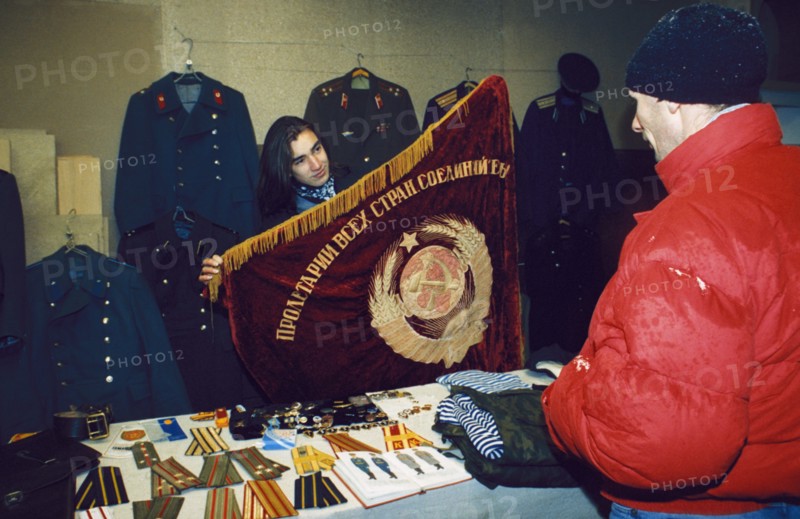 A woman selling soviet souvenirs at the outdoor market (vernissazh) in izmailovo park, moscow, russia, 1990s.