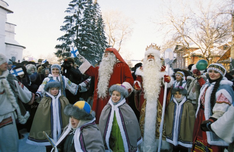 Grandfather frost (ded moroz) and his lappish colleague, santa claus with school children in the vologda region, november 2000.