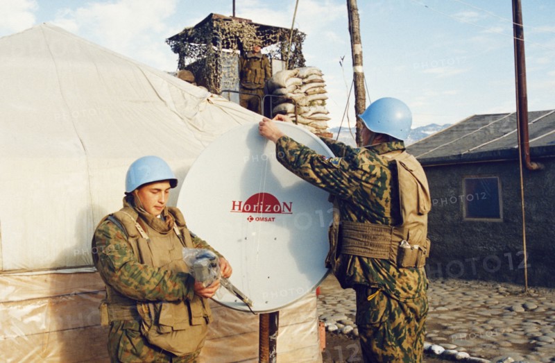 Russian un peacekeepers in abkhazia adjusting a satellite dish at their camp during the conflict between georgia and abkhazia, february 2003.