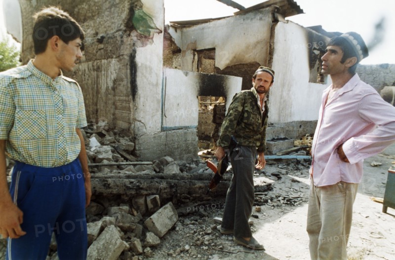 An opposition fighter and residents of the budenny state farm in tajikistan, september 1992.