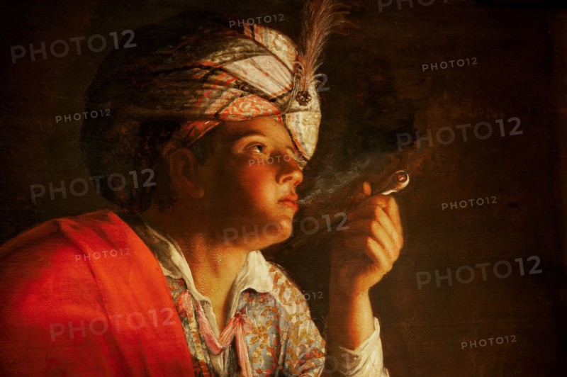 Young man smoking a pipe