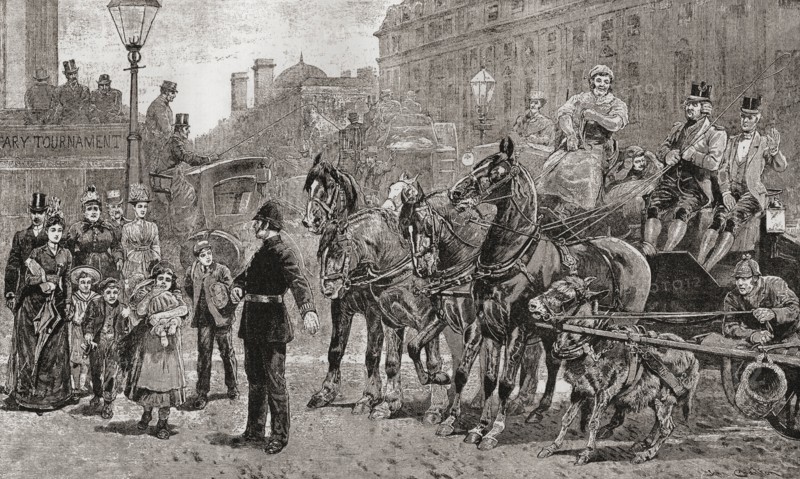 A policeman stops the traffic on a busy crossing to allow pedestrians to cross the road, London, England,