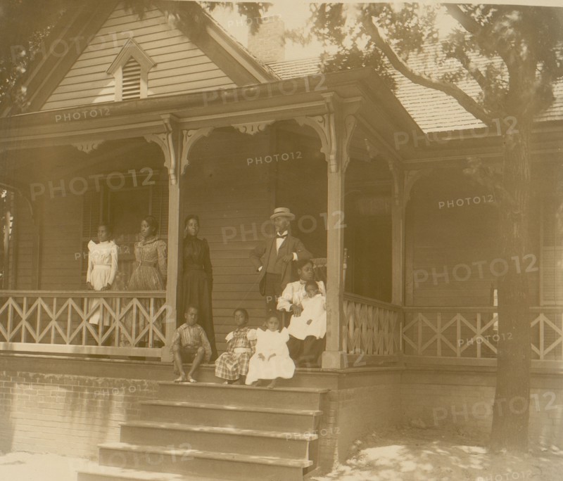 Home of an African American lawyer, Atlanta, Georgia, with men, women, and children posed on porch of house