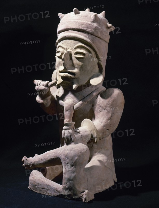 Male figure sitting cross-legged and hands objects.