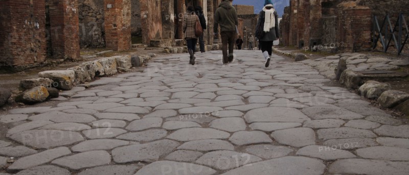 Pompeii. Tourists in the cobbled street.