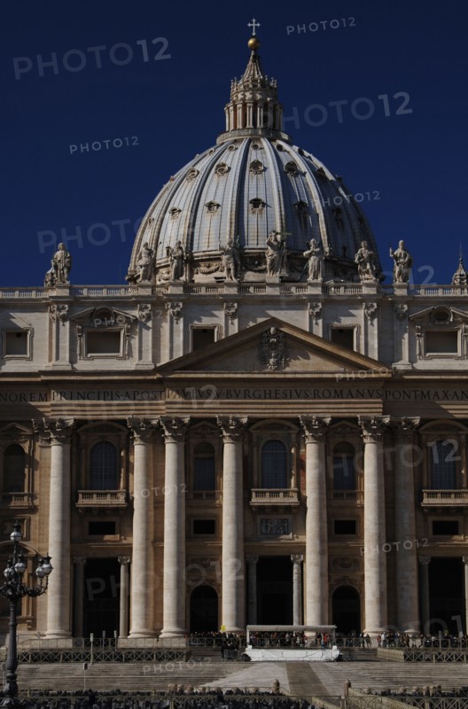 Tourists in St. Peters Square and Basilica of St. Peters.