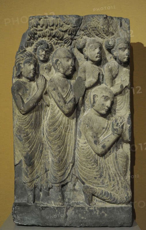 Monks and laymen from a scene of the Buddha sermon.