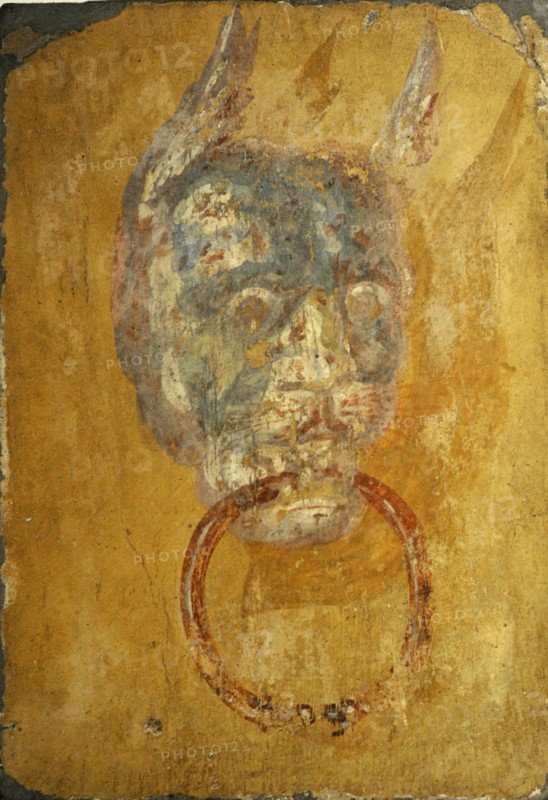 Roman fresco depicting a door frame with a monstrous head.
