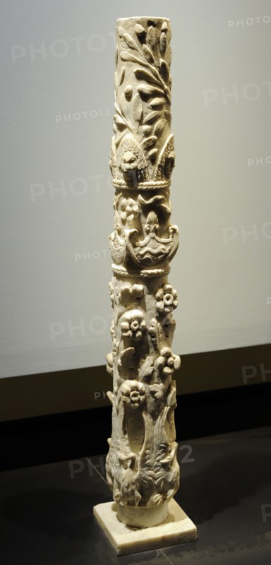 Roman column with flowering branches, swans with deployed wings, dolphins, baskets of fruit, theater masks and olive branches.