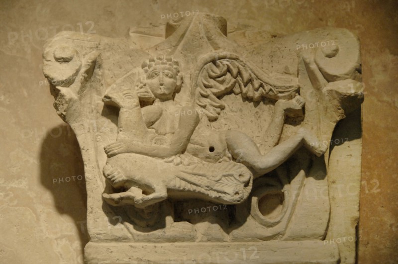 Capital decorated with relief of cupid on a peacock.