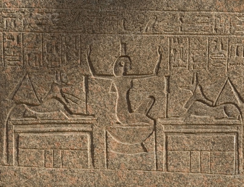 Goddess Nephthys between two figures of god Anubis.