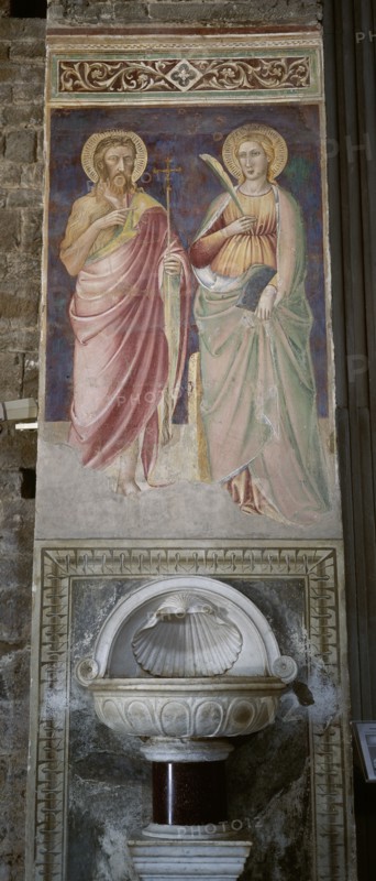 Italy. Florence. Mural painting with saints and stoup. 14th-15th century. Basilica of San Miniato al Monte.