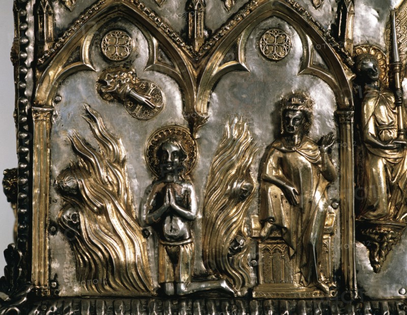 Reliquary casket of Saint Cucuphas. Wooden gilded silver. 14th Century. Detail. Saint Cucuphas in a bonfire from where demons are fleeing. Over the Saint, the Hand of God (dextera domini) while Maximian is watching from his throne. Ca. 1303. Spain.