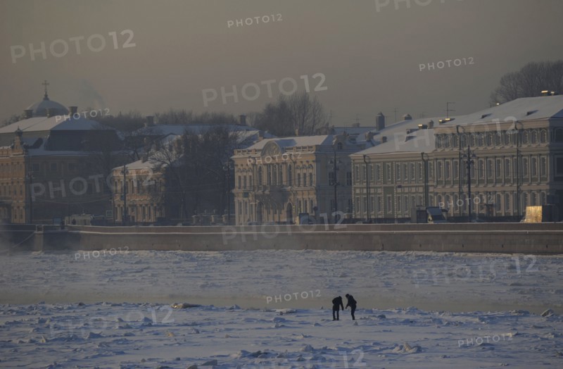 People walking on the frozen Neva river during the winter surface.