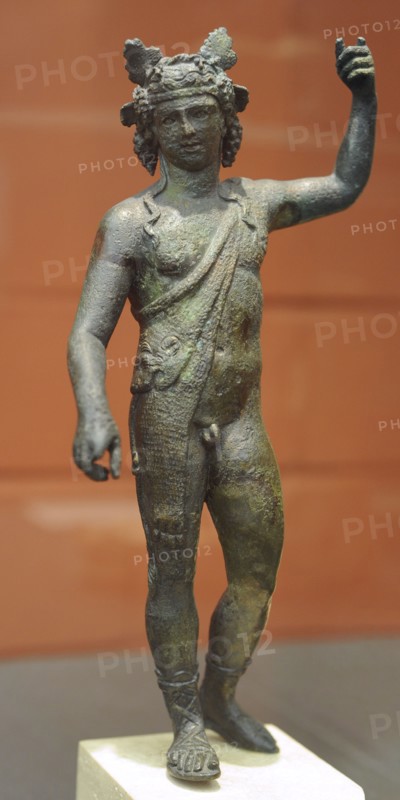 Bronze statuette of God Dionysus with panther skin, sandals and crown of clusters and vine leaves.