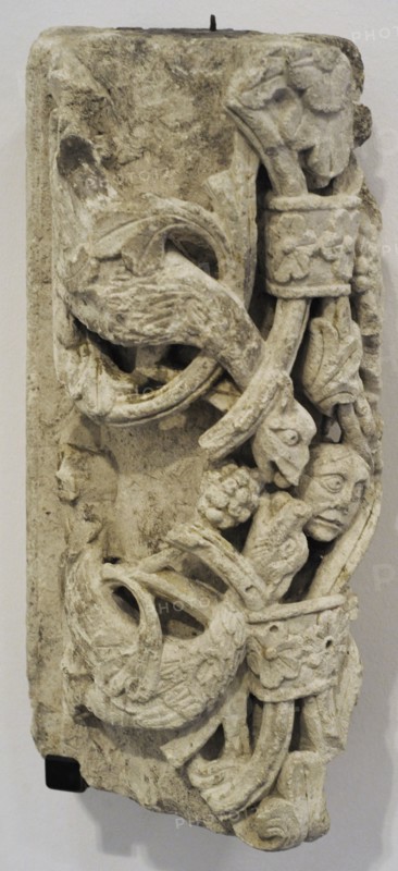 Arch segment with dragon and human head.