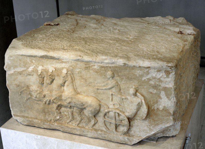 Base of a dedication. Scene from the apobates race.