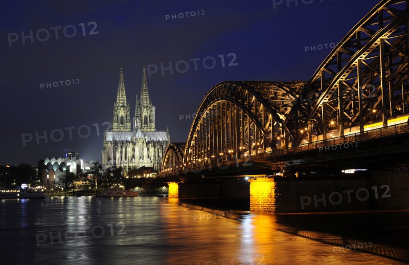 Night view of the Hohenzollern Bridge over the Rhine River.