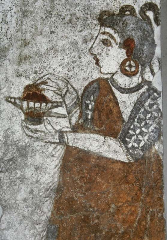 Priestess making offerings.