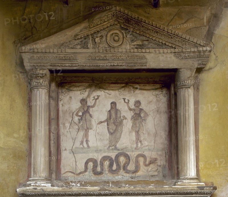 Fresco depicting two Lares flanking a genius. The snake, associated with the prosperity, approaches an altar.