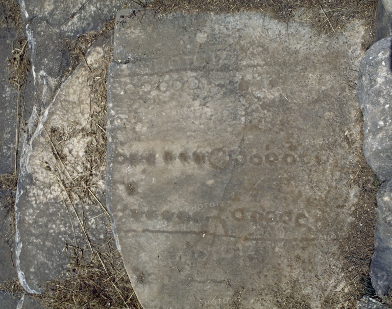 Roman games engraved into seats of the stadium, upper bleachers.