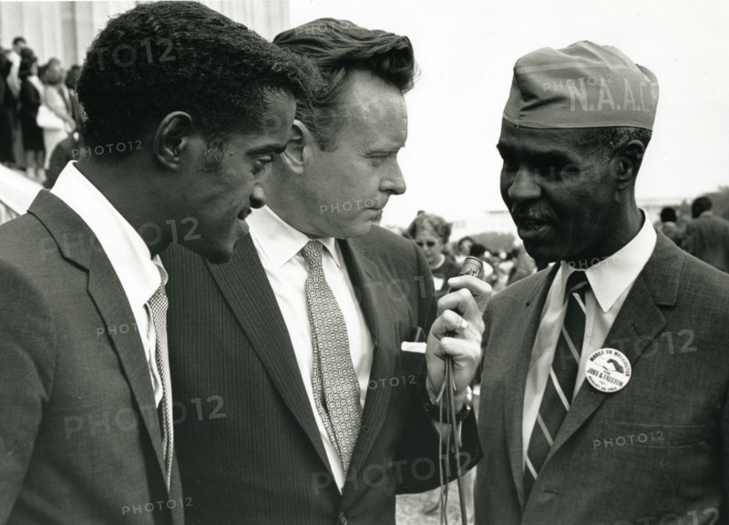 Actor Sammy Davis, Jr and Roy Wilkins being interviewed