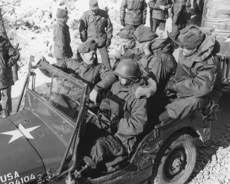 President-elect Dwight D. Eisenhower (front seat, left); General Mark W. Clark, Commander-in-Chief, United Nations Command (back seat, center), and members of their party begin a tour of installations in a jeep at the headquarters of the 2nd US Inf. Division. Korea, 12-5-52.