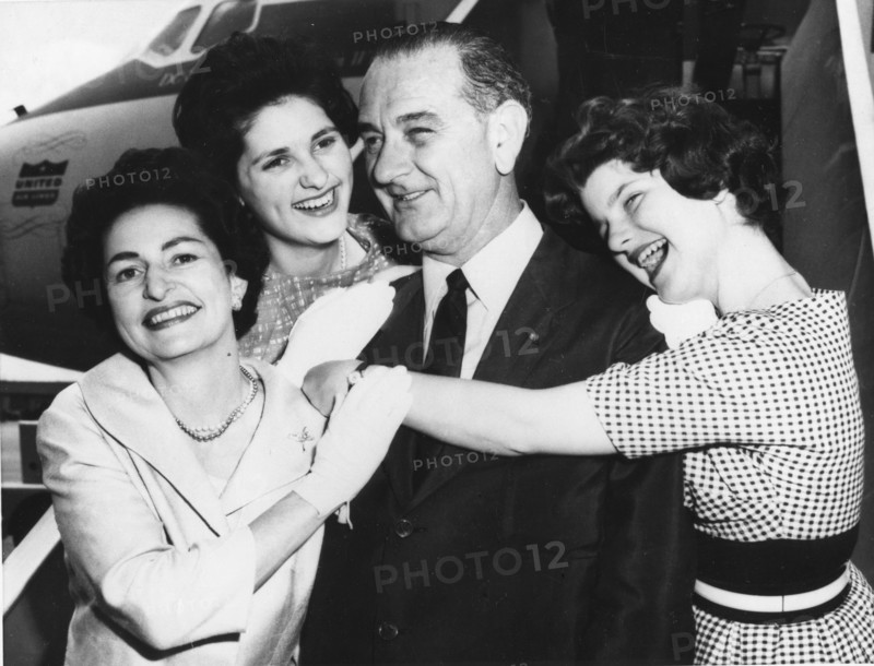 Senator Lyndon B. Johnson is embraced by his wife, Lady Bird (left) and their daughters Lynda (left) and Lucy (right). The Johnsons were on their way to the Democratic Convention in Los Angeles. 7-7-60.