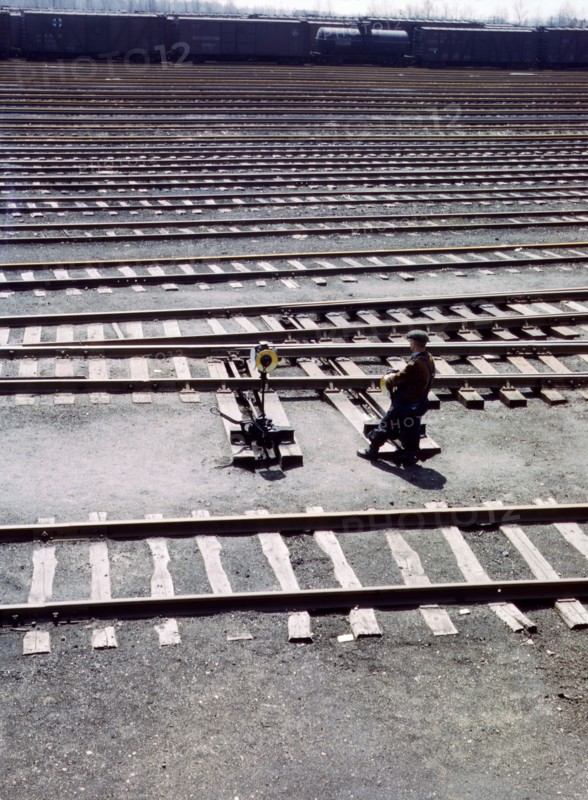 Switchman throwing a switch a C and NW RR's Proviso yard, Chicago, Ill. April 1943.