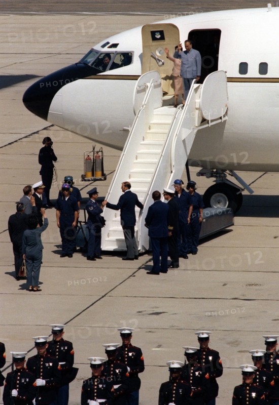 Vice Premier Geng Biao of China and his wife wave goodbye as they prepare to leave California aboard Vice President Walter Mondale's official aircraft..