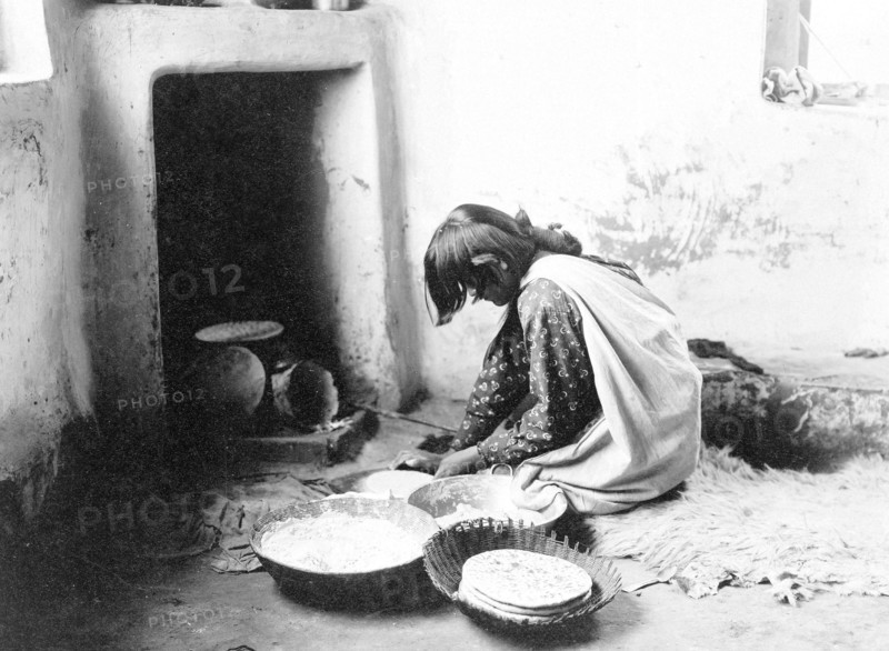 Edward S. Curits Native American Indians - Zuni woman making bread circa 1903.