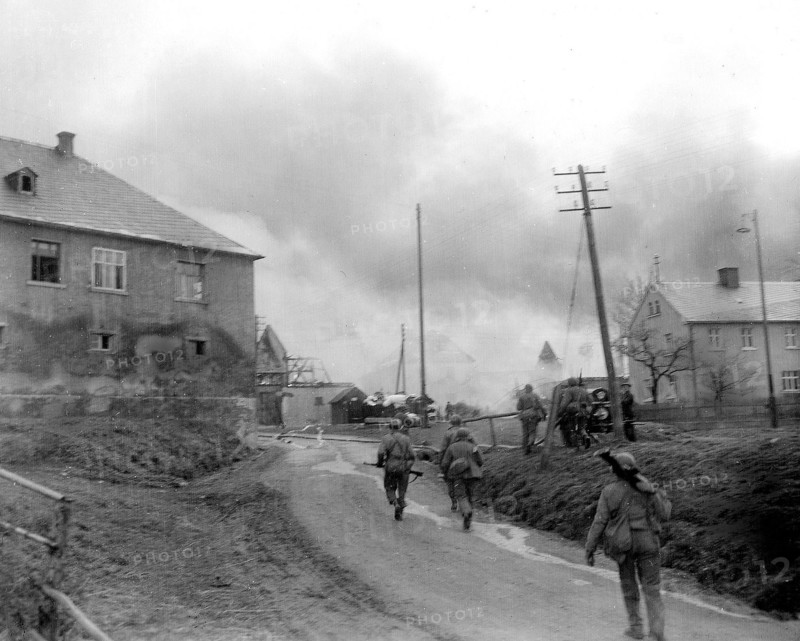 Infantrymen of the 90th Division, 3rd US Army, fight their way through Gottsmanngrun, Germany, being held by a company of Germans who are holding on to prevent the Americans from crossing the Saale River circa 4/1945.