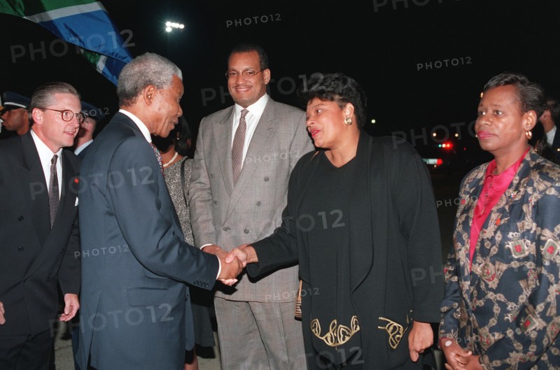 South Africa's president, Nelson Mandela, takes time to bid farewell to those waiting near by on the flight line prior to his departure..